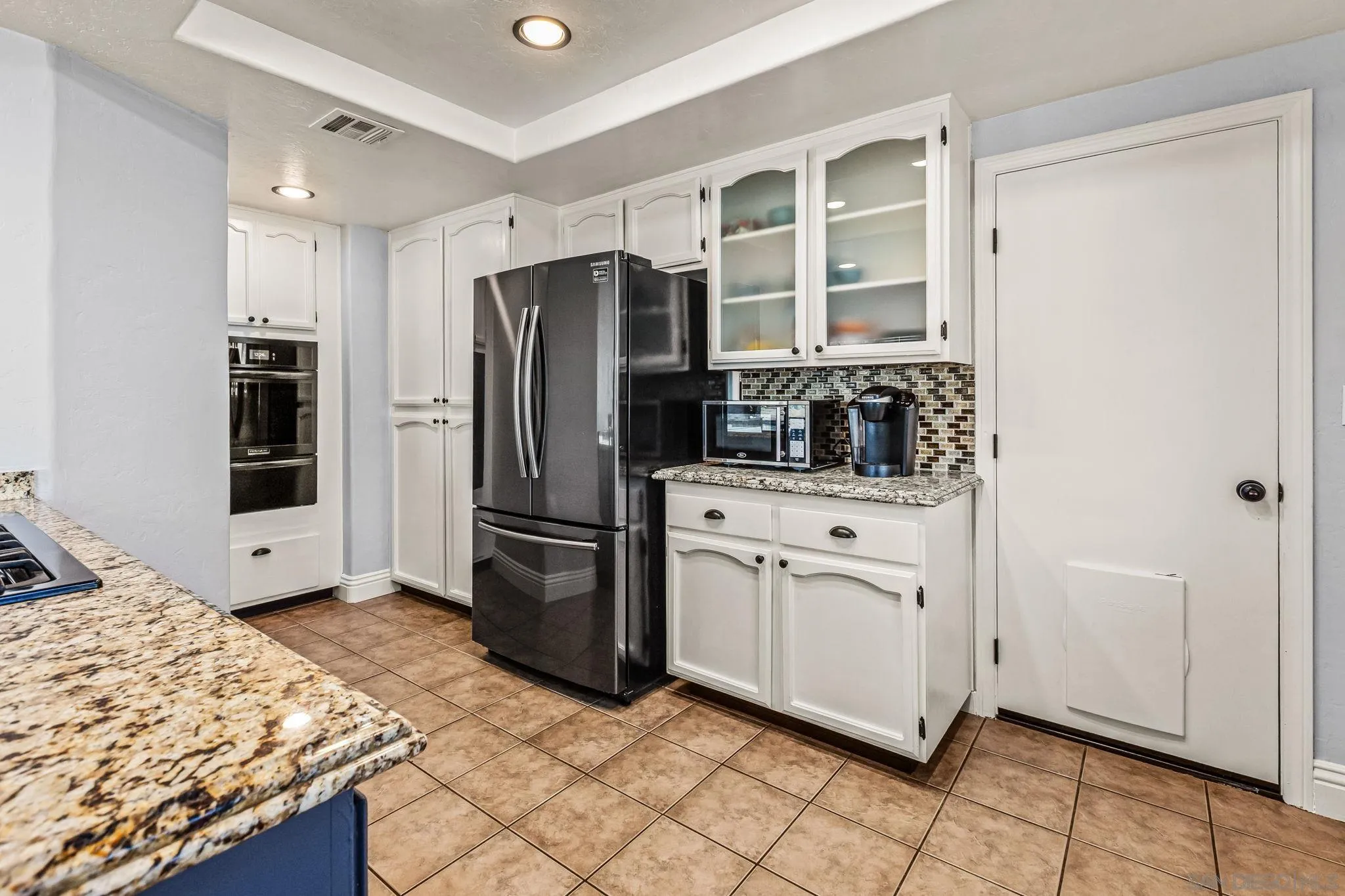 16319 Scarbery Road Ramona, CA 92065 - Photo 12 of 37 a kitchen with stainless steel appliances a refrigerator sink and cabinets