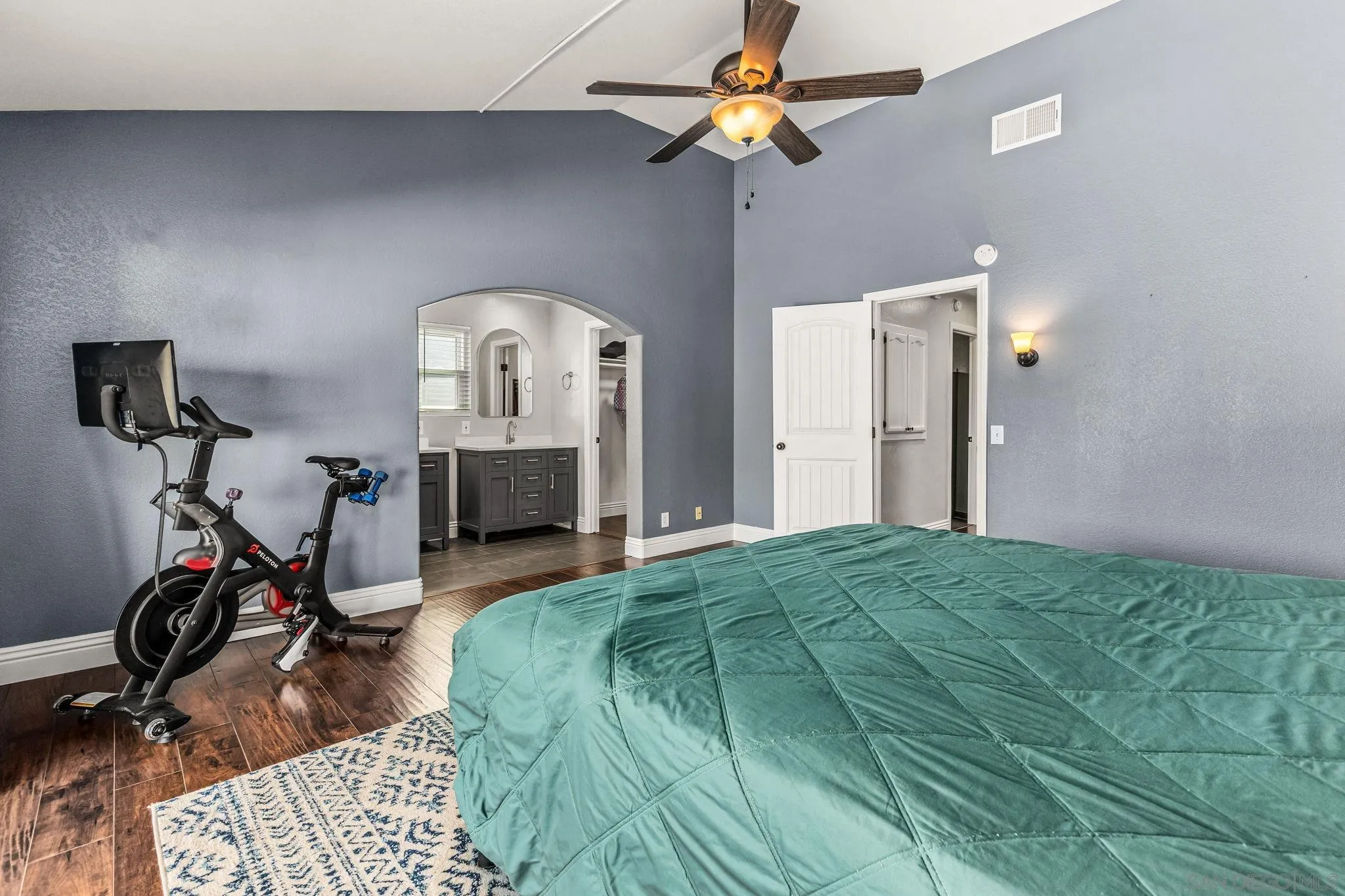 16319 Scarbery Road Ramona, CA 92065 - Photo 19 of 37 a bedroom with a bed a clock on the wall and dresser