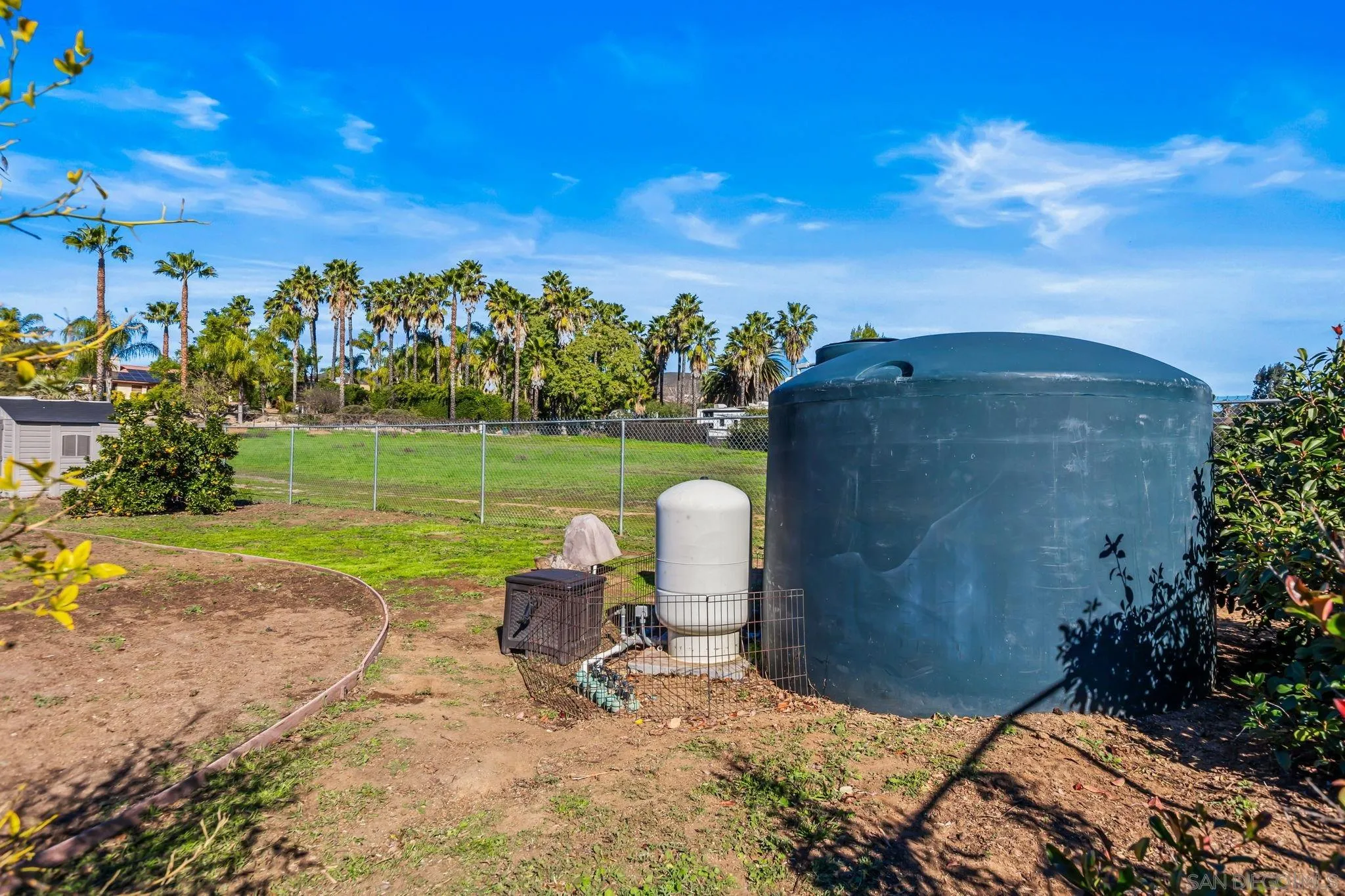 16319 Scarbery Road Ramona, CA 92065 - Photo 26 of 37 a view of a garden with a bench in the patio