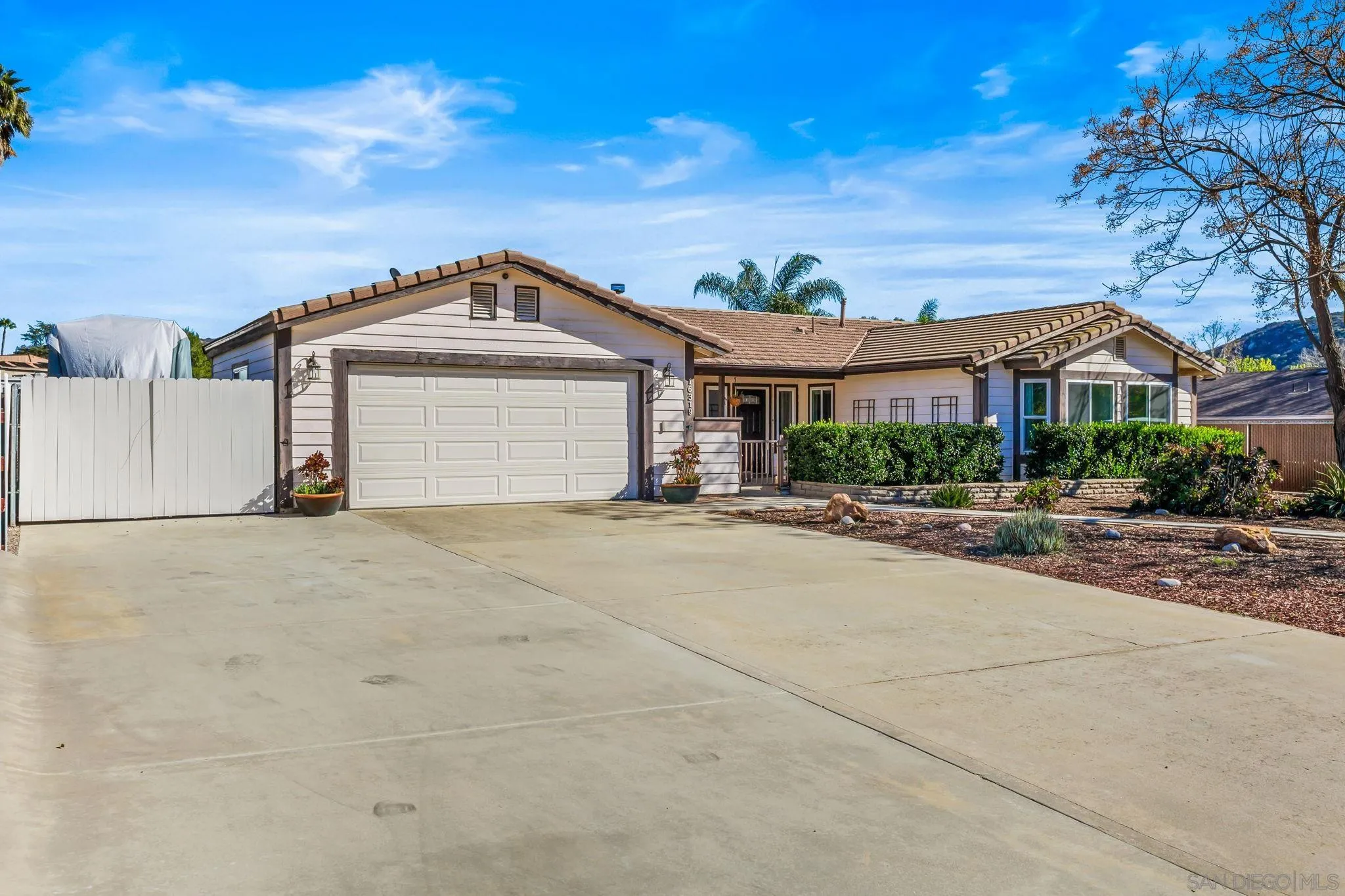 16319 Scarbery Road Ramona, CA 92065 - Photo 27 of 37 a front view of a house with a yard and garage