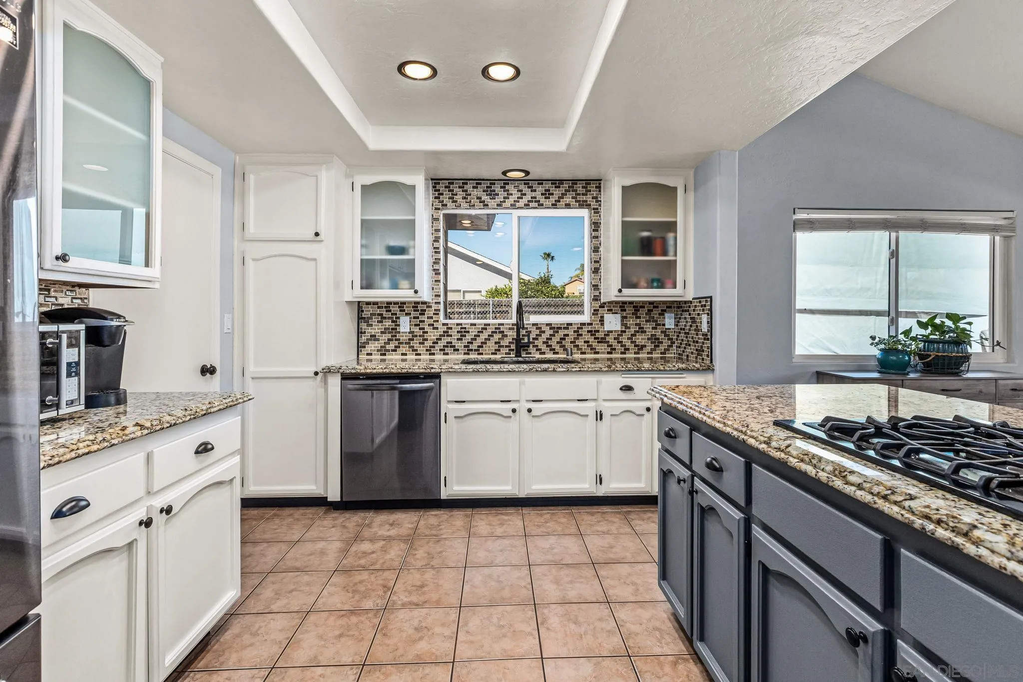 16319 Scarbery Road Ramona, CA 92065 - Photo 9 of 37 a kitchen with stainless steel appliances granite countertop a stove a sink and a microwave