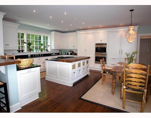 Undisclosed Address Old Greenwich, CT 06870 - Photo 6 of 8 a kitchen with a sink stove and wooden cabinets