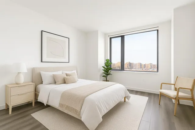 a living room with furniture a flat screen tv and a window