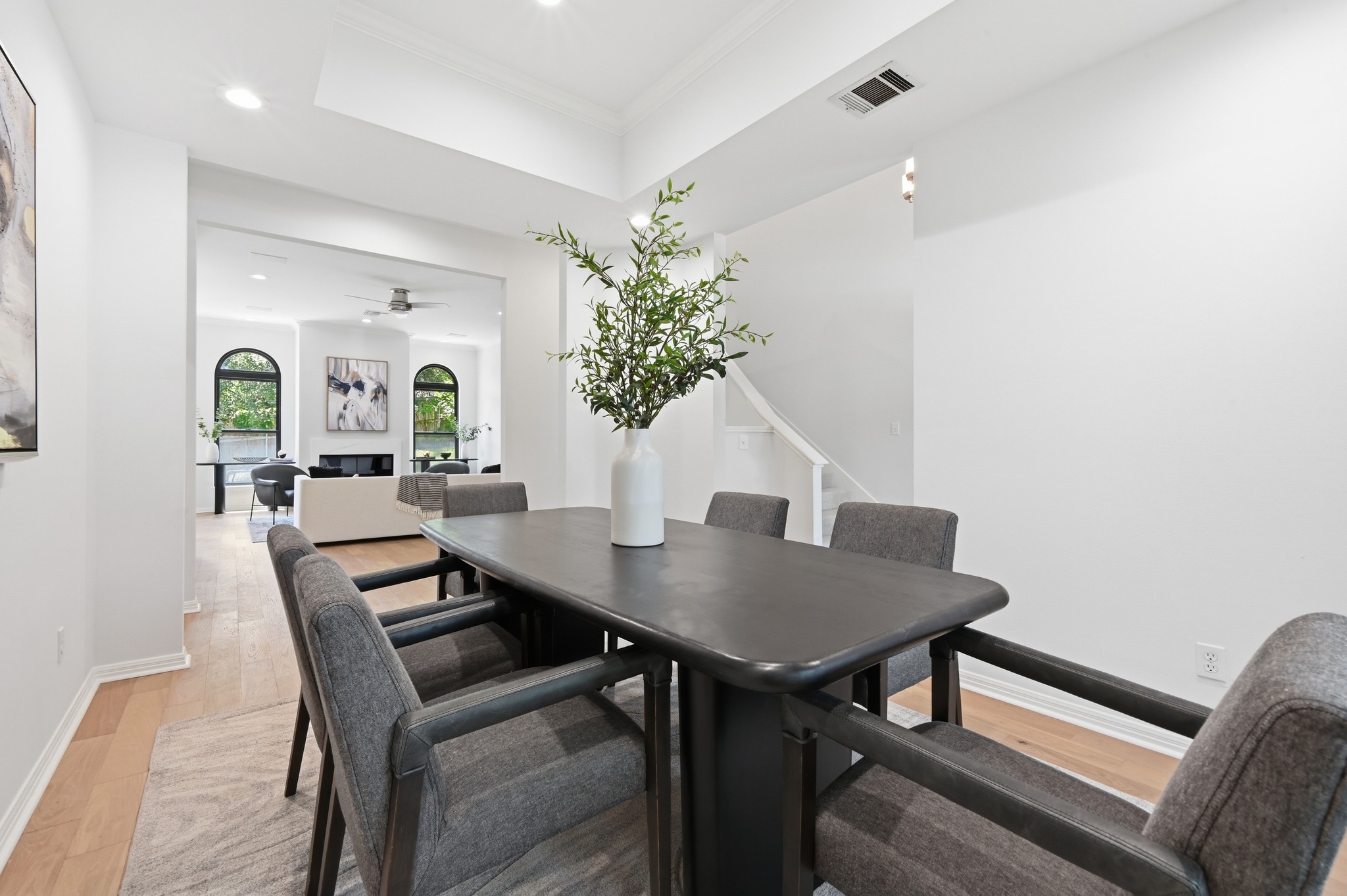 1107 Bowie Road Austin, TX 78733 - Photo 8 of 40 A graceful dining area, crowned with tray ceilings, offers seamless transitions to a bright living space.