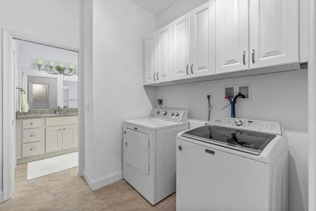 a utility room with sink dryer and washer