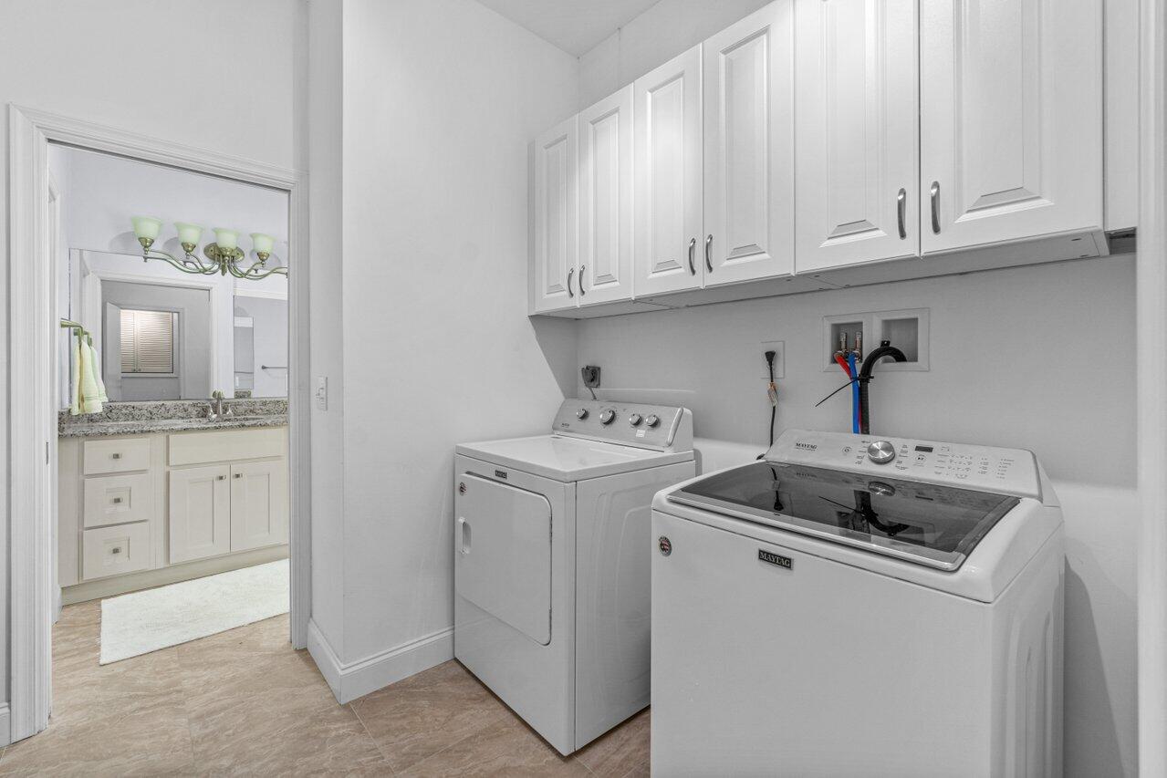 122 Andrews Avenue, Unit 2A Delray Beach, FL 33483 - Photo 15 of 39 a utility room with sink dryer and washer