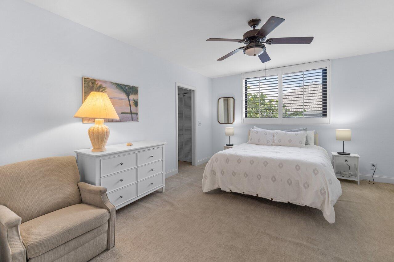122 Andrews Avenue, Unit 2A Delray Beach, FL 33483 - Photo 19 of 39 a bedroom with a bed dresser and a window