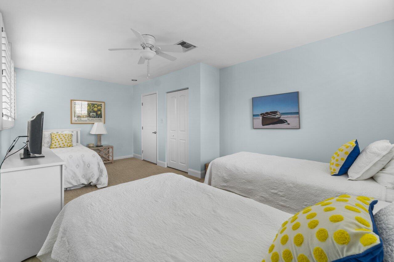 122 Andrews Avenue, Unit 2A Delray Beach, FL 33483 - Photo 23 of 39 a bedroom with two beds and painted walls