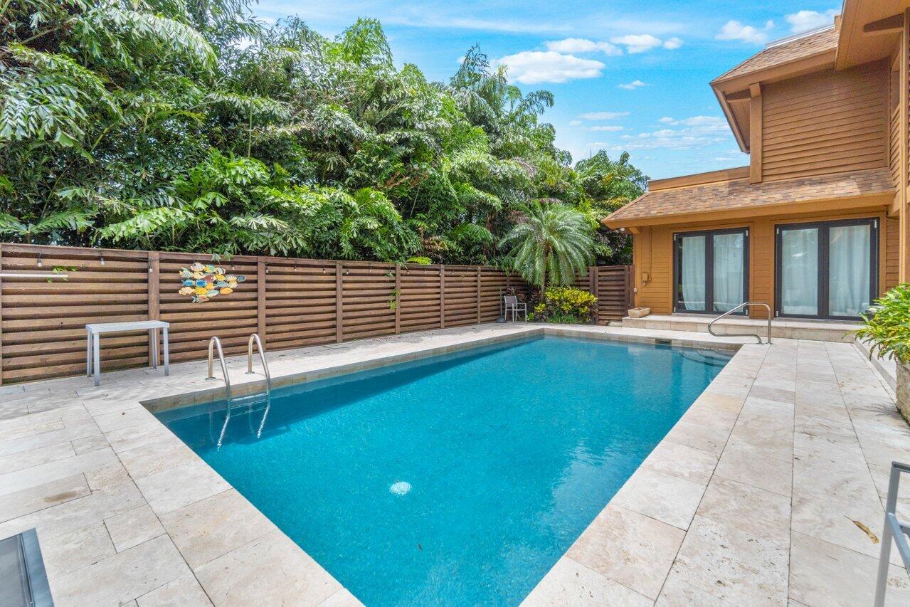 122 Andrews Avenue, Unit 2A Delray Beach, FL 33483 - Photo 28 of 39 a view of a patio with table and chairs and potted plants