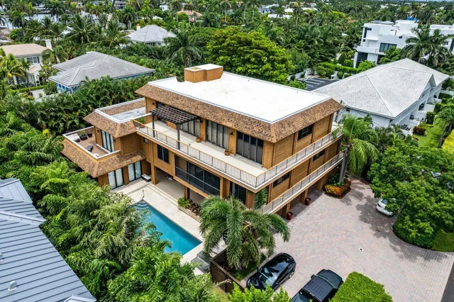 an aerial view of a house with a yard