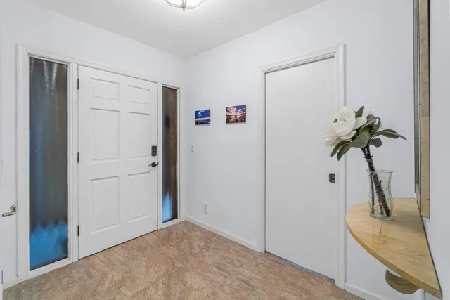 a view of a room with a sink and mirror