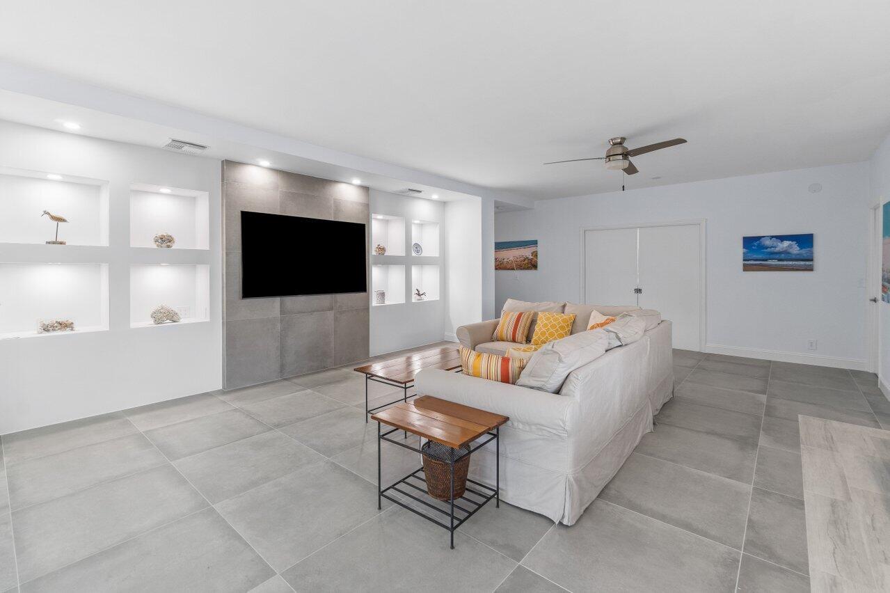 122 Andrews Avenue, Unit 2A Delray Beach, FL 33483 - Photo 4 of 39 a living room with furniture and a flat screen tv