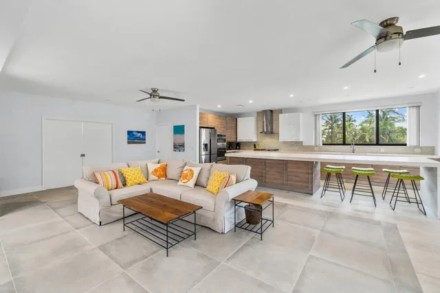 a living room with furniture a kitchen view and a kitchen view