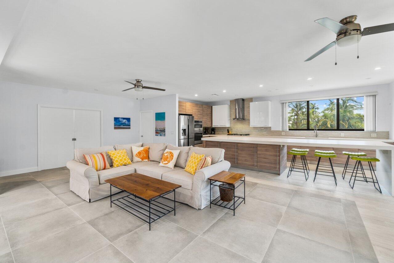 122 Andrews Avenue, Unit 2A Delray Beach, FL 33483 - Photo 7 of 39 a living room with furniture a kitchen view and a kitchen view