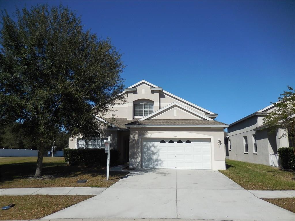 7940 Terrace Ridge Drive Temple Terrace, FL 33637 - Photo 1 of 1 a front view of a house with a yard and garage