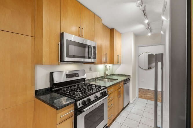 2 Hawthorne Place, Unit 16M Boston, MA 02114 - Photo 11 of 36 a kitchen with a stove a microwave and refrigerator