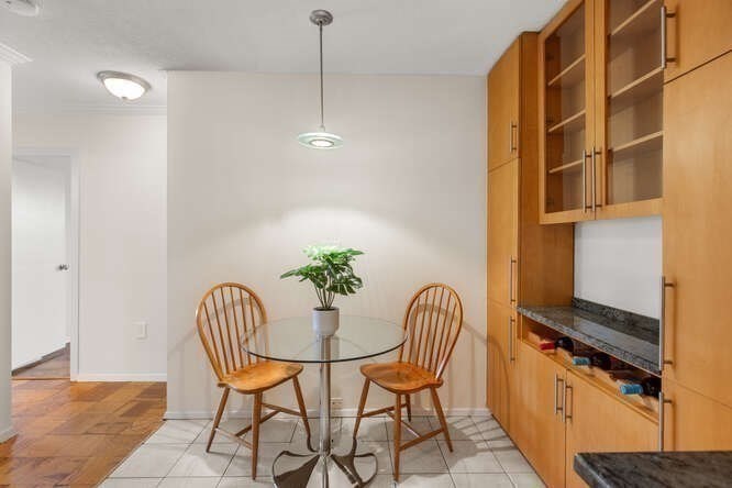 2 Hawthorne Place, Unit 16M Boston, MA 02114 - Photo 15 of 36 a view of a dining room with furniture and a potted plant
