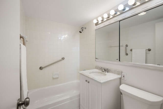 2 Hawthorne Place, Unit 16M Boston, MA 02114 - Photo 18 of 36 a bathroom with a sink a toilet and shower