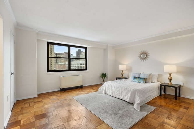 2 Hawthorne Place, Unit 16M Boston, MA 02114 - Photo 19 of 36 a bedroom with a large bed and a window