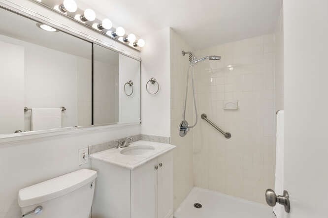 2 Hawthorne Place, Unit 16M Boston, MA 02114 - Photo 21 of 36 a bathroom with a sink a toilet and shower