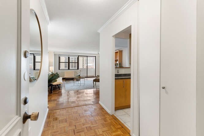 2 Hawthorne Place, Unit 16M Boston, MA 02114 - Photo 7 of 36 a hallway with a dining table and a mirror