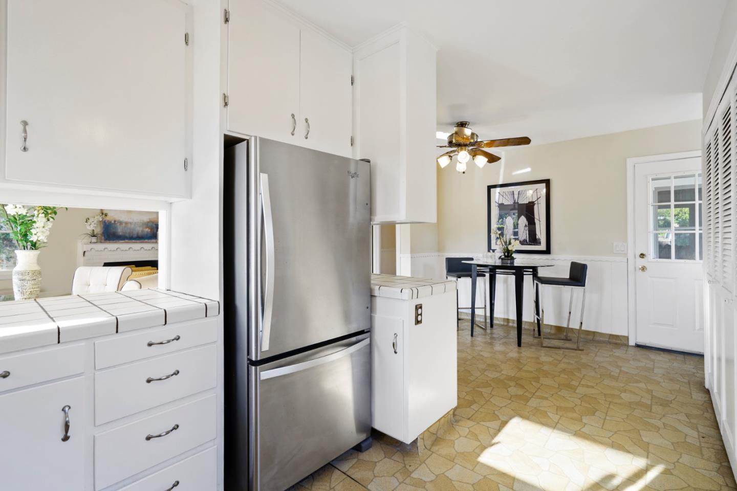 3755 Bay Road Menlo Park, CA 94025 - Photo 12 of 29 a kitchen with granite countertop a refrigerator a stove a dining table and chairs