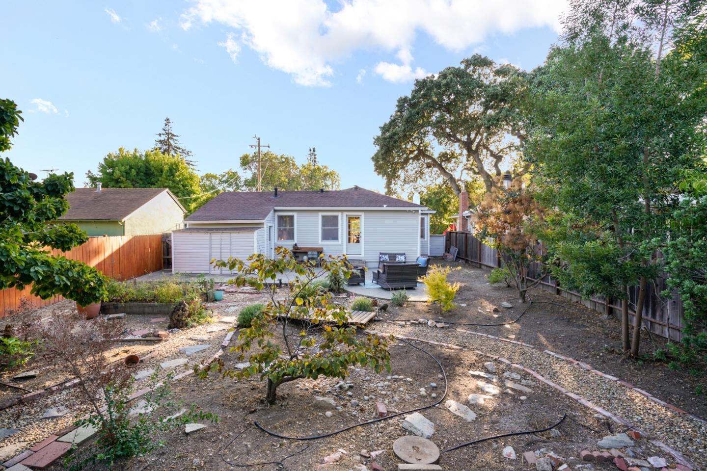 3755 Bay Road Menlo Park, CA 94025 - Photo 26 of 29 a view of a house with backyard sitting area and garden