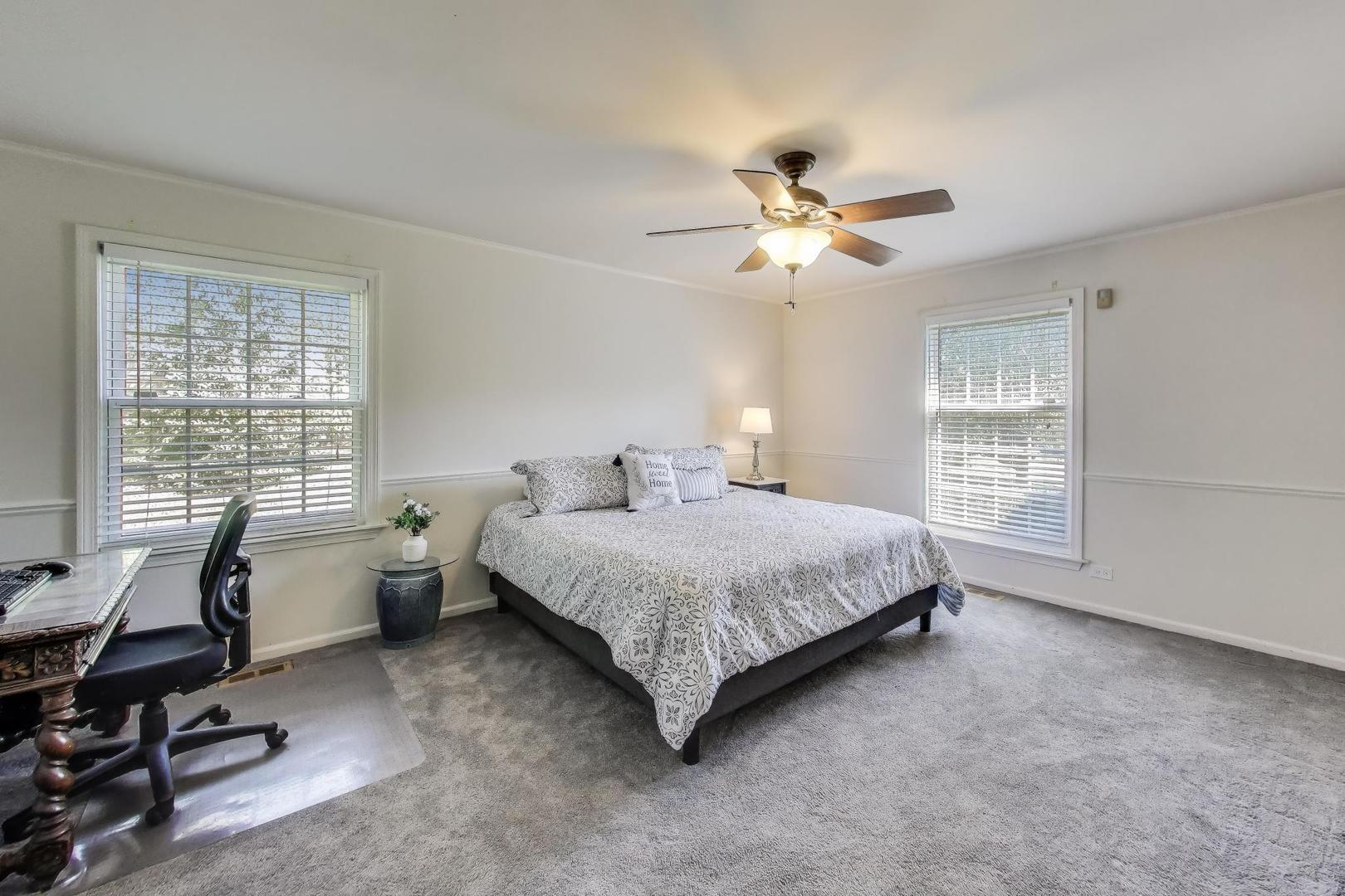 924 Stonefield Circle Inverness, IL 60067 - Photo 19 of 50 a spacious bedroom with a bed a chair and a large window