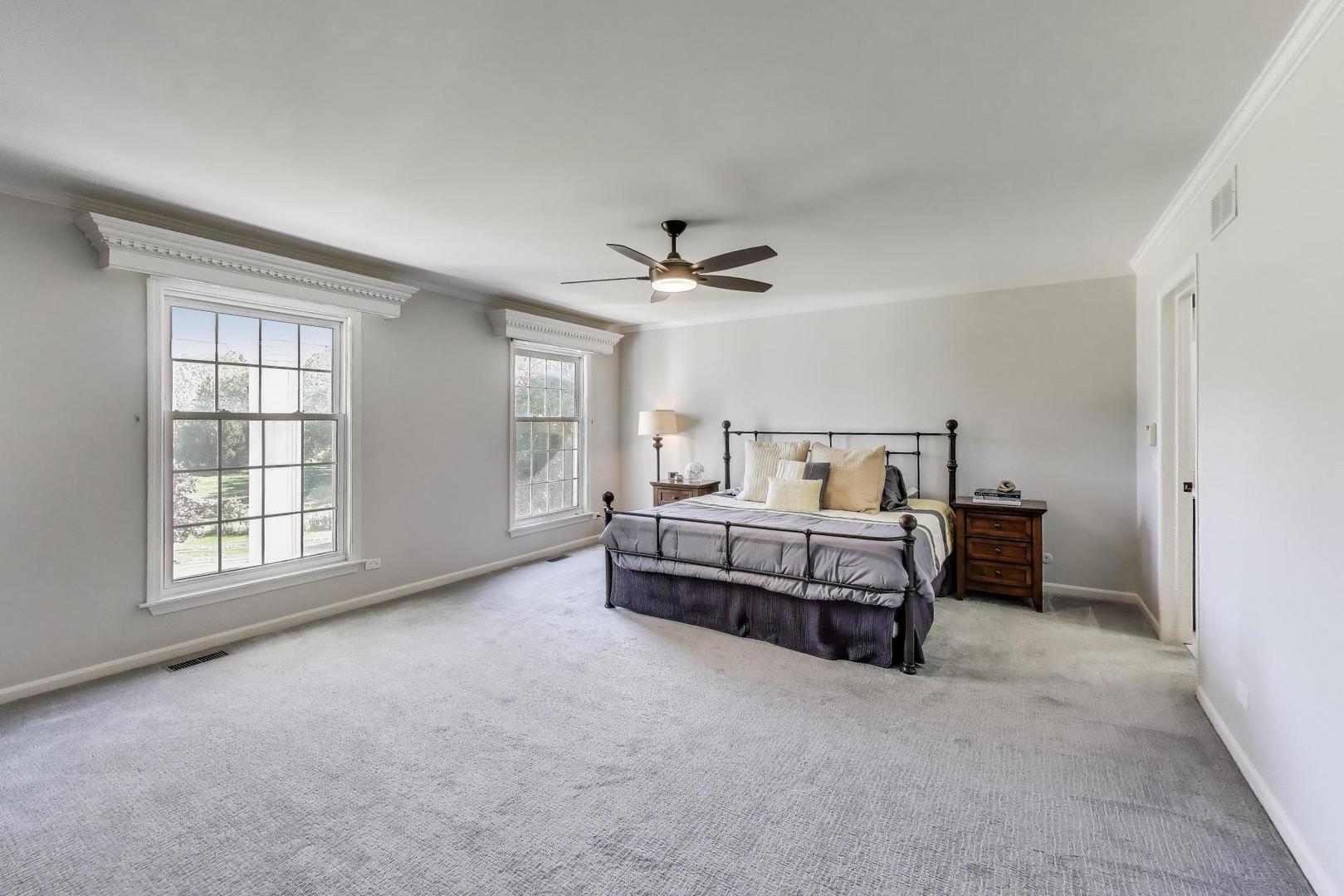 924 Stonefield Circle Inverness, IL 60067 - Photo 24 of 50 a spacious bedroom with a bed and a ceiling fan