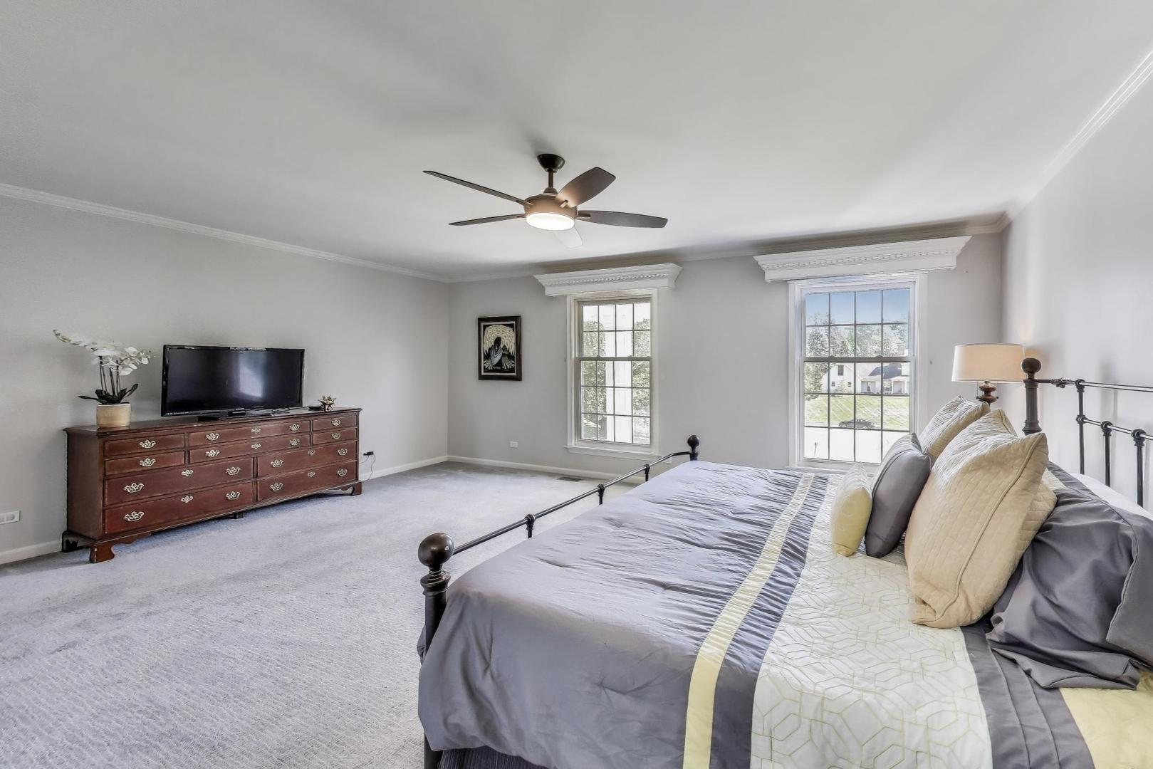 924 Stonefield Circle Inverness, IL 60067 - Photo 25 of 50 a spacious bedroom with a bed and a flat screen tv