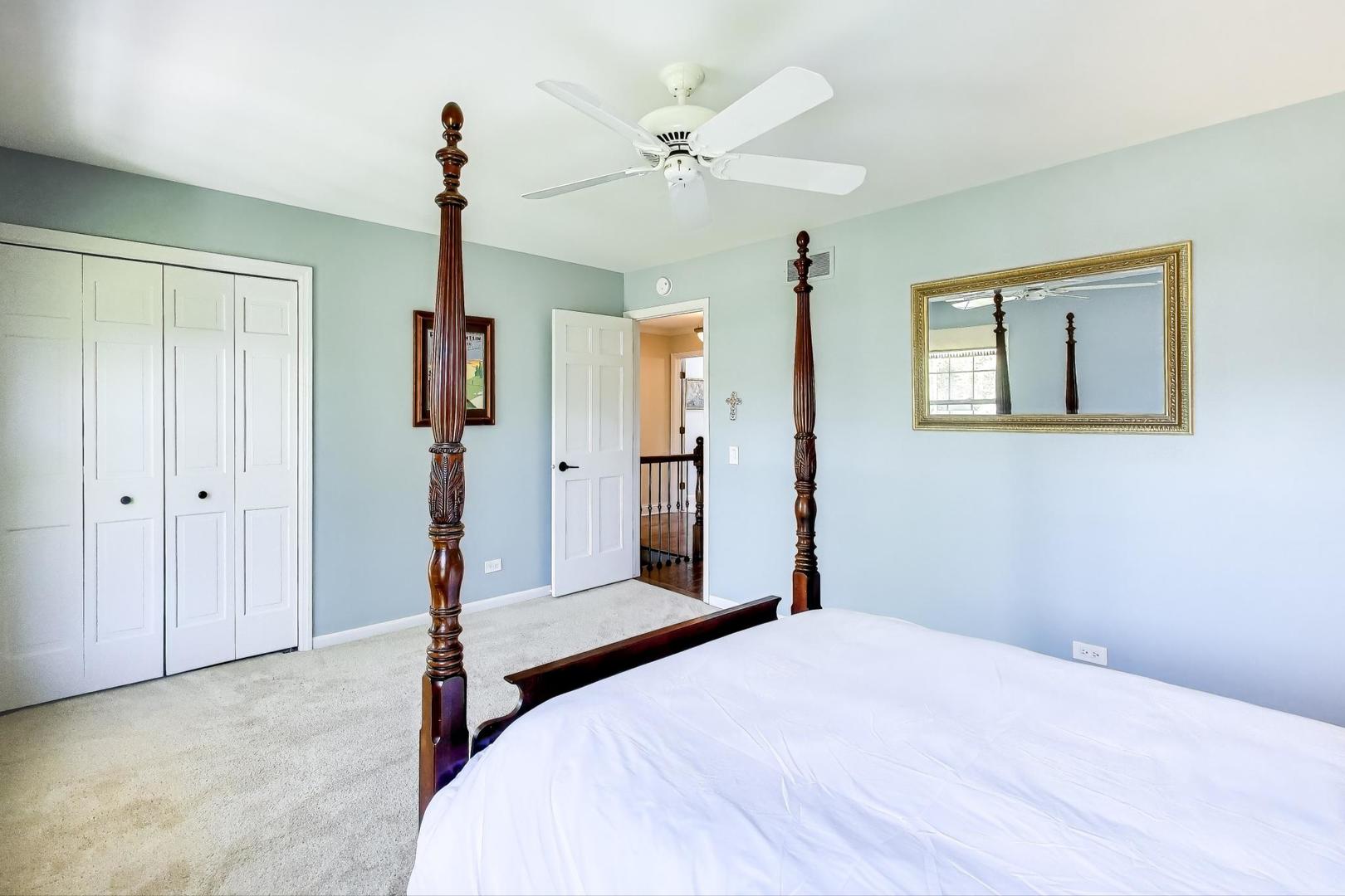 924 Stonefield Circle Inverness, IL 60067 - Photo 30 of 50 a bedroom with a bed and a chandelier