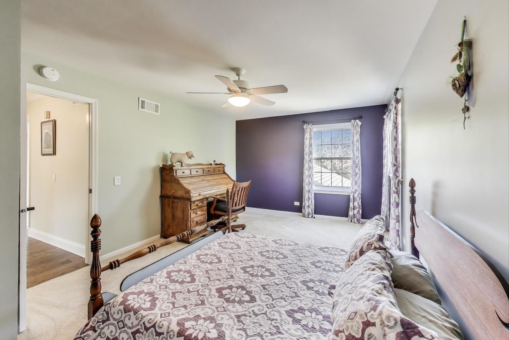 924 Stonefield Circle Inverness, IL 60067 - Photo 32 of 50 a bedroom with a bed and a chandelier