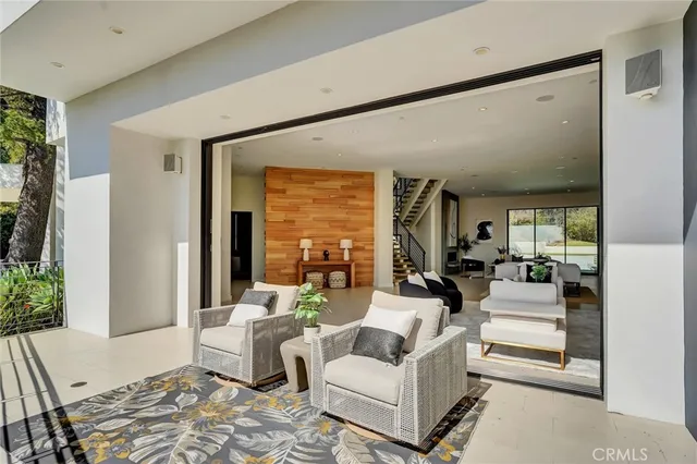 a living room with fireplace furniture and a large window