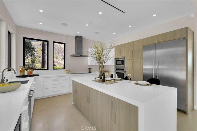 a view of staircase with lots of frames on wall and a chandelier