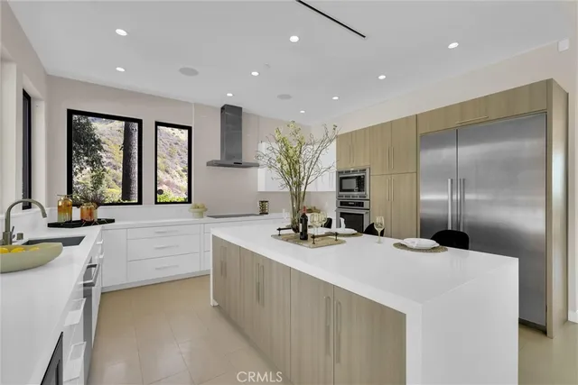 a view of staircase with lots of frames on wall and a chandelier