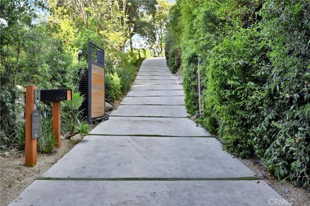 a living room with furniture a chandelier and a large window