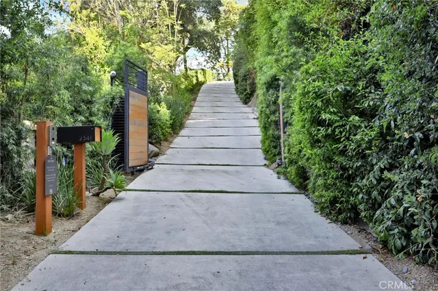a living room with furniture a chandelier and a large window