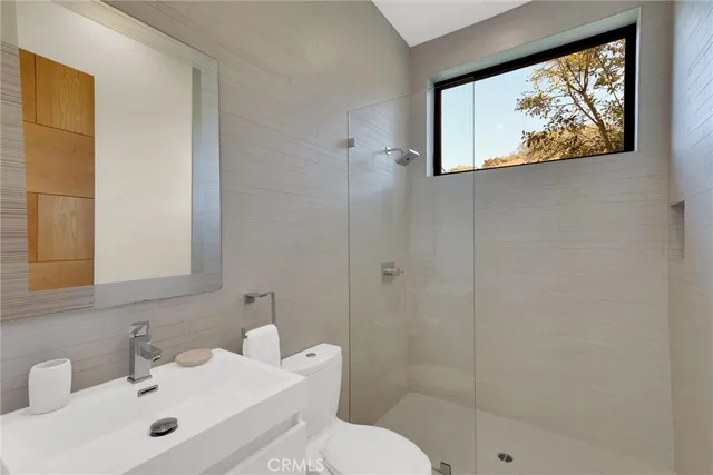 a bedroom with a bed and large window