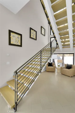 a spacious bathroom with a mirror a toilet and a shower
