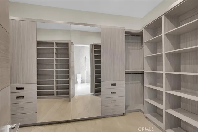 a bedroom with furniture and a large window