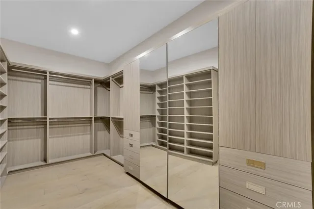 a bedroom with a large bed and a night stand