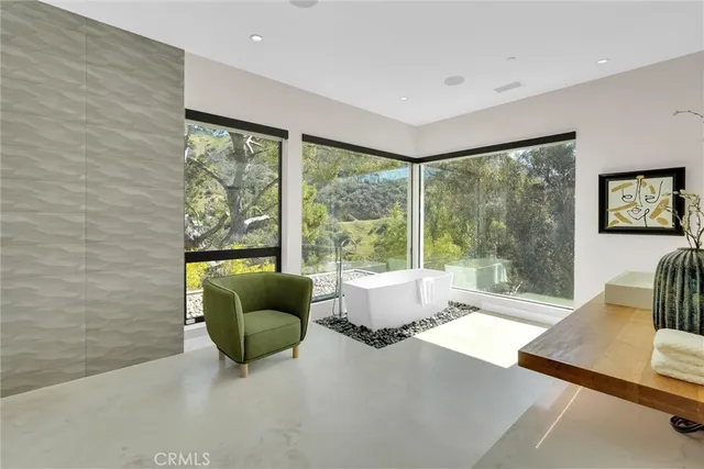 a bedroom with a bed and a painting on the wall