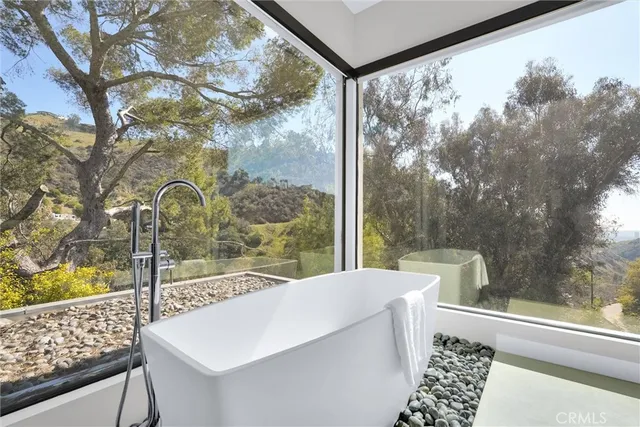 a bathroom with a toilet sink and a mirror