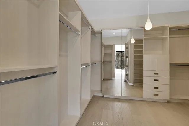 a view of a white house with a tree in front of it