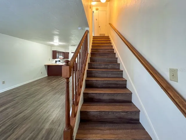 a view of entryway and hall with wooden floor