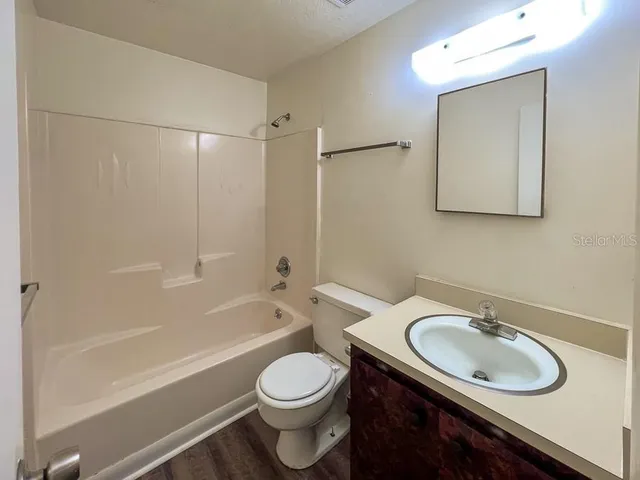 a bathroom with a sink toilet a mirror and shower