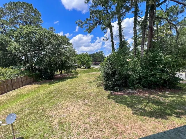 a view of backyard with swimming pool