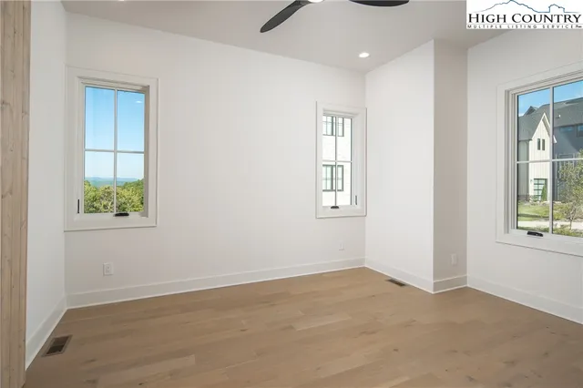 an empty room with windows and closet