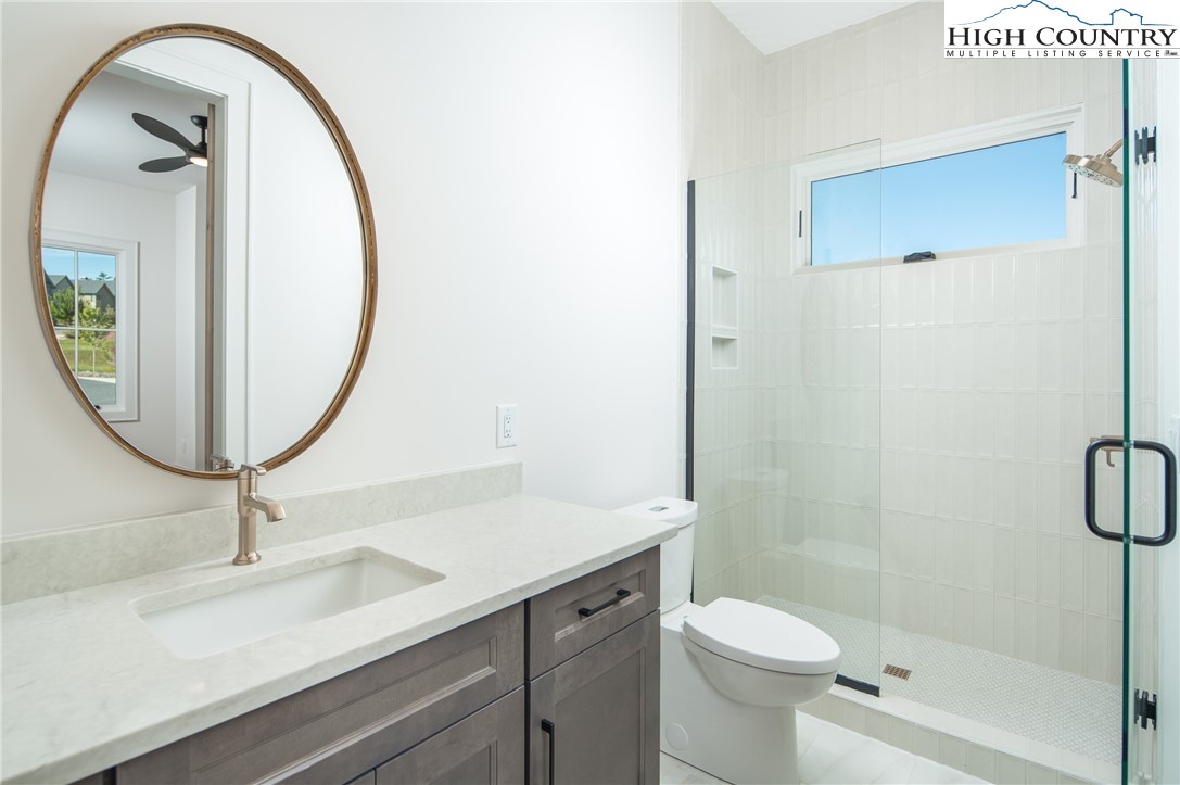 359 Calico Court Boone, NC 28607 - Photo 16 of 50 a bathroom with a sink a toilet and a mirror