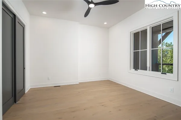 a view of a livingroom with a ceiling fan and window